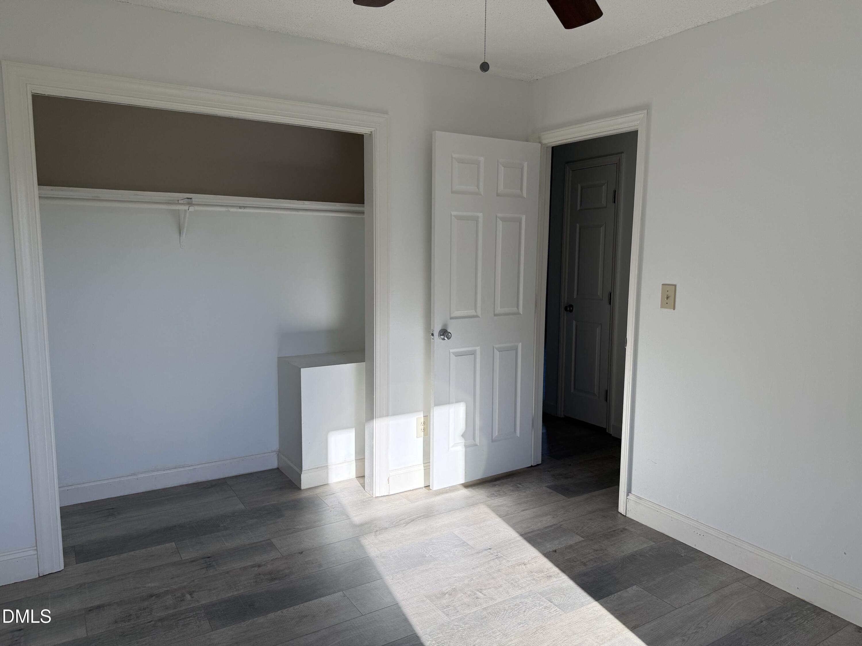 5509 Sandy Run Knightdale, NC 27545 - Photo 19 of 21 a view of an empty room with wooden floor and closet