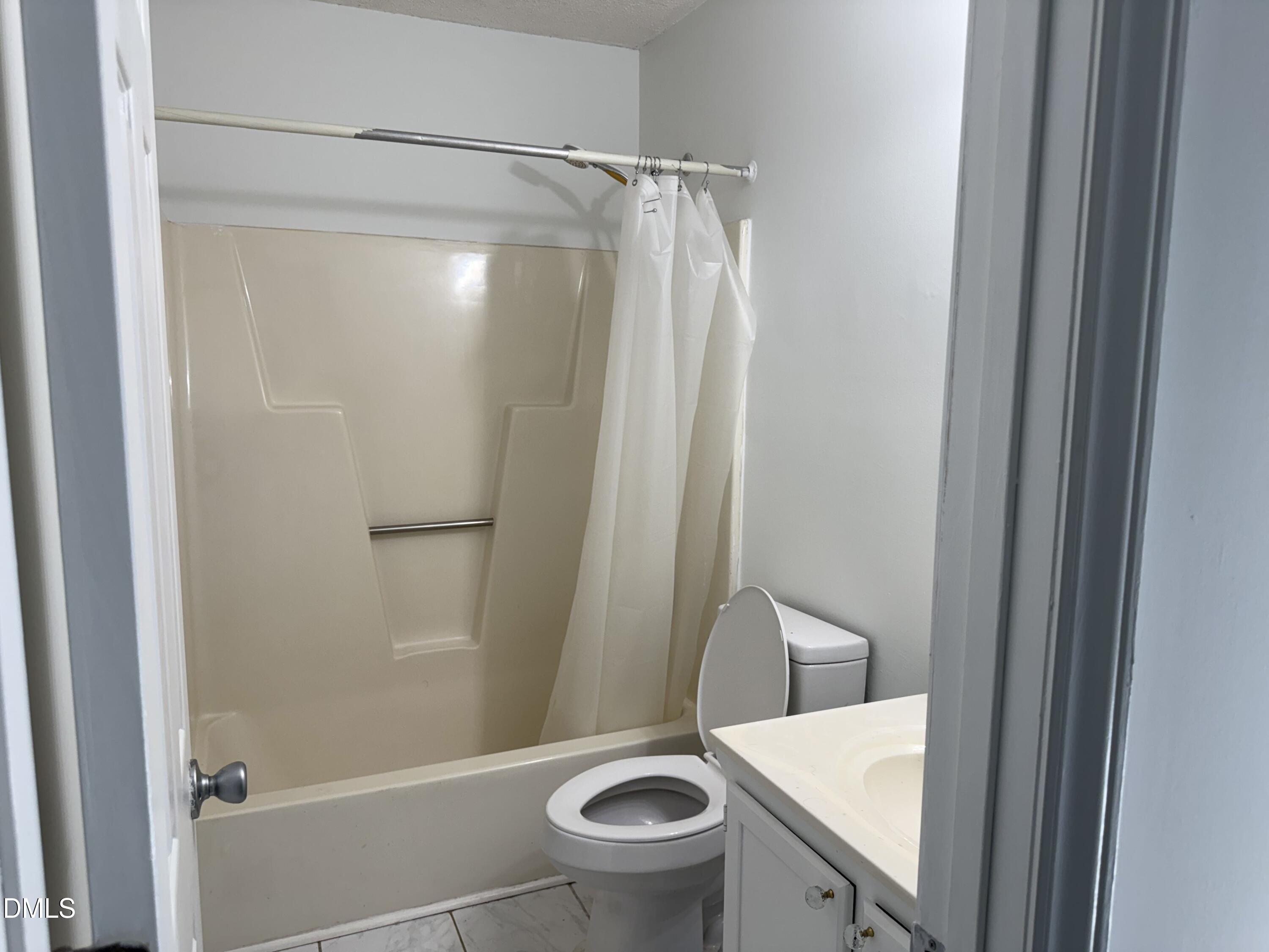 5509 Sandy Run Knightdale, NC 27545 - Photo 20 of 21 a bathroom with a granite countertop bathtub shower and toilet
