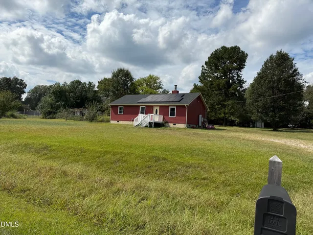 a front view of house with yard and entertaining space