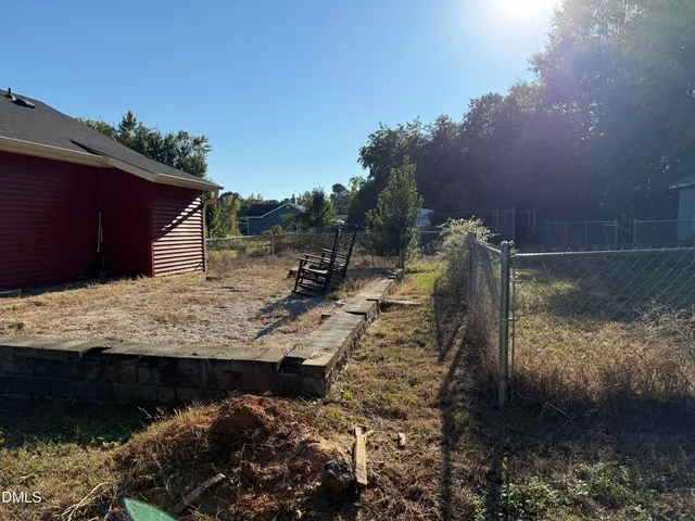 a view of a wooden house with a yard