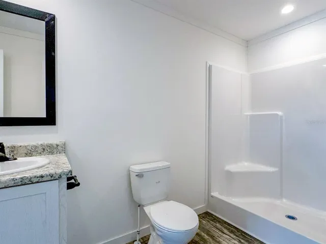 a white toilet sitting next to a bathroom sink