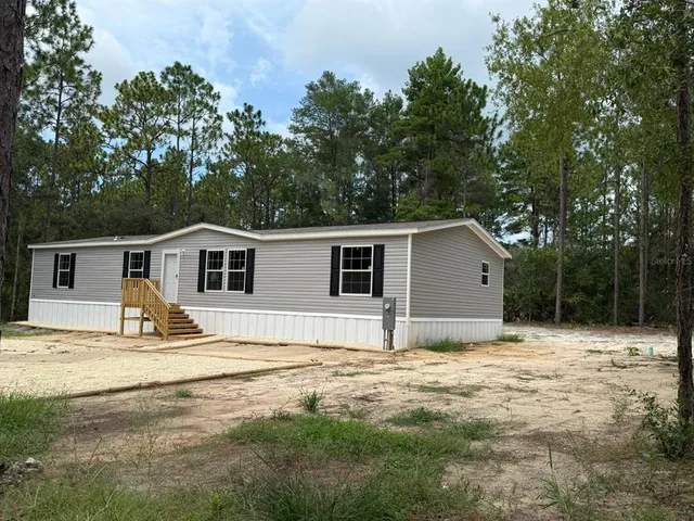 a house that has a large tree in front of it