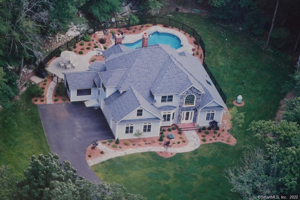 an aerial view of a house with garden space and a house