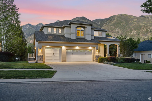 12317 Cypress Point Way Draper, UT 84020 - Photo 3 of 41 Stucco exterior residence with a multi-car garage, arched entryway, and pitched shingle roof