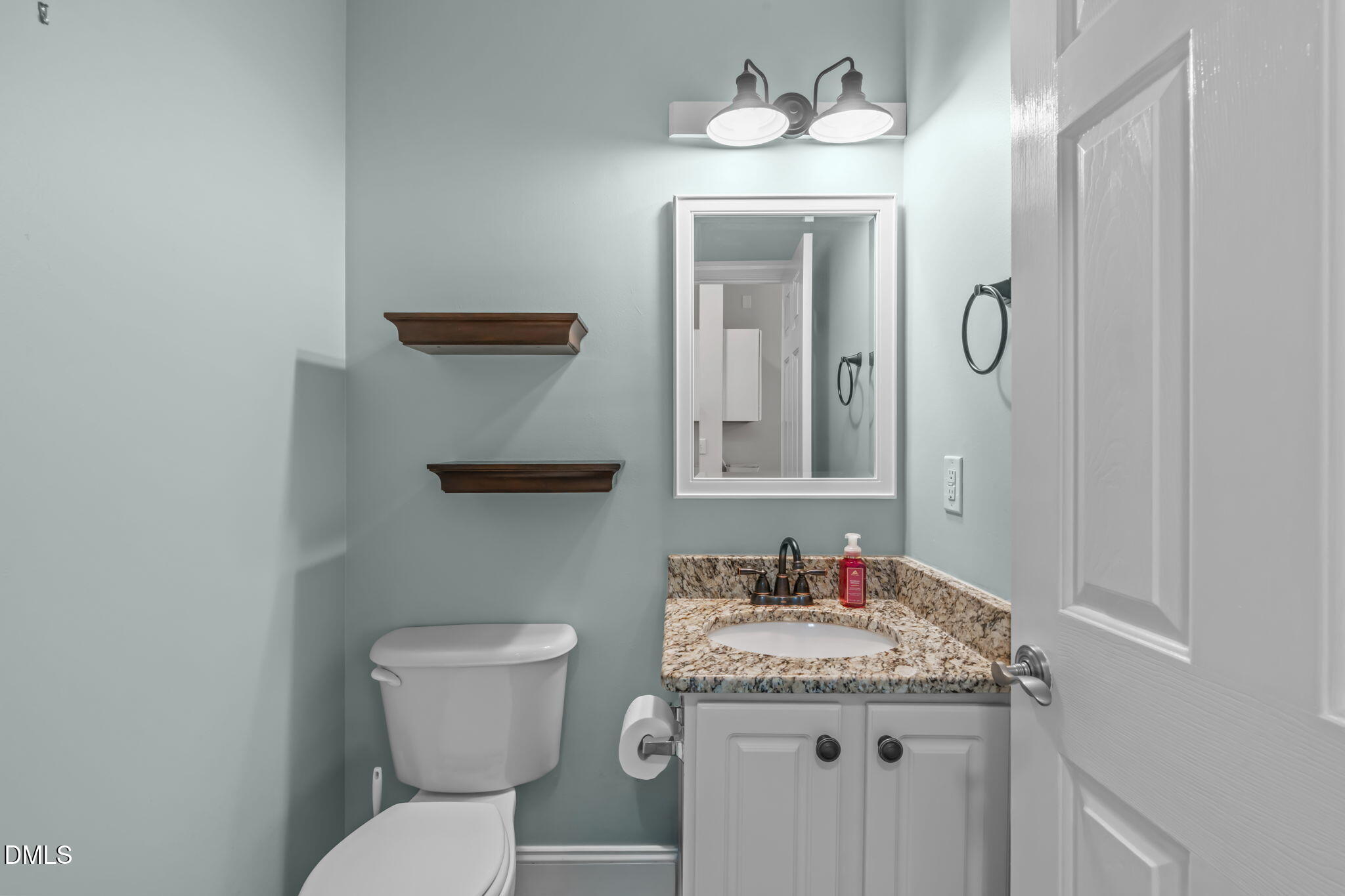 2501 Springfield Park Drive Raleigh, NC 27614 - Photo 20 of 44 a bathroom with a granite countertop sink a toilet and a mirror