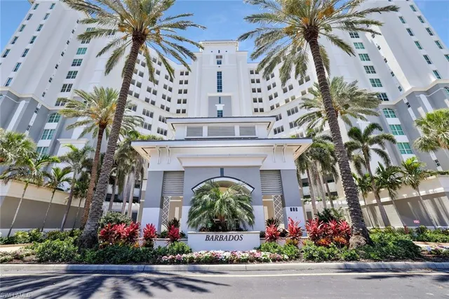 a living room with furniture a chandelier and a large mirror
