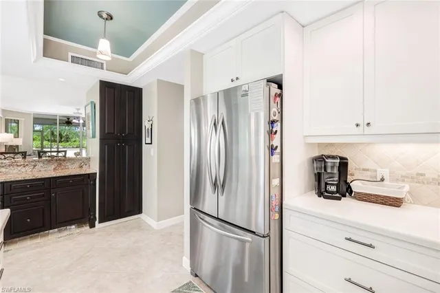 a spacious bathroom with a double vanity sink a large mirror and a bathtub