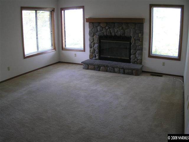 2601 Chaparral Drive Reno, NV 89509 - Photo 3 of 5 an empty room with a fireplace