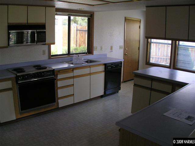 2601 Chaparral Drive Reno, NV 89509 - Photo 4 of 5 a kitchen with stainless steel appliances granite countertop a stove a sink and a microwave