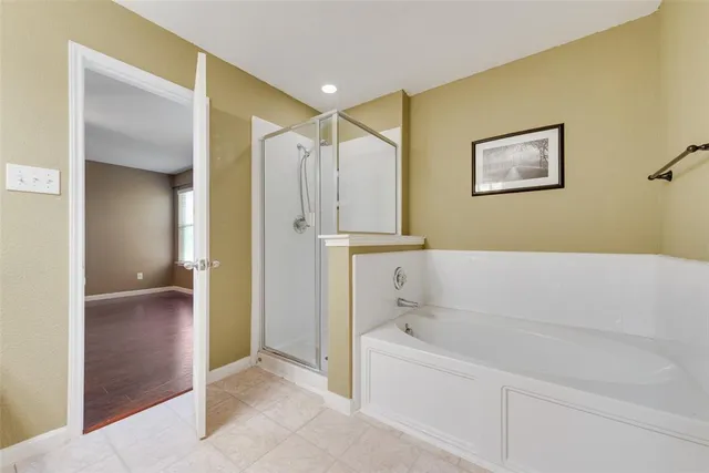 a bathroom with a bathtub and a shower