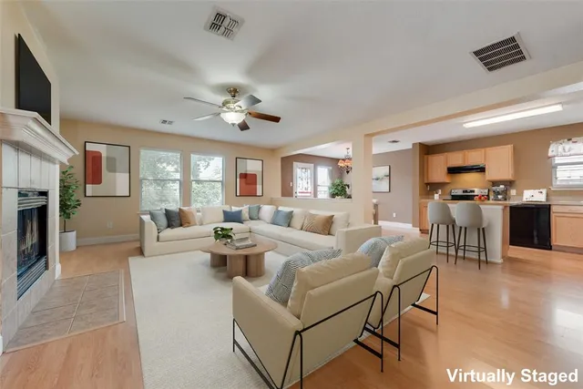 a living room with fireplace furniture and a wooden floor