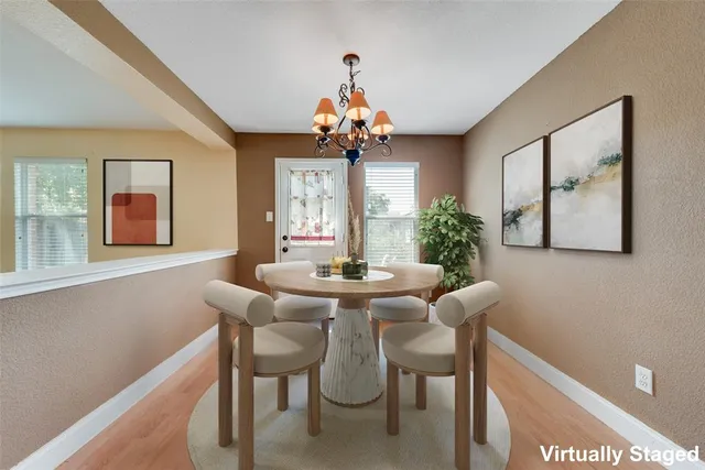 a view of a dining room with furniture and wooden floor