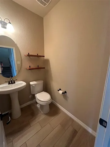 a bathroom with a toilet and a sink