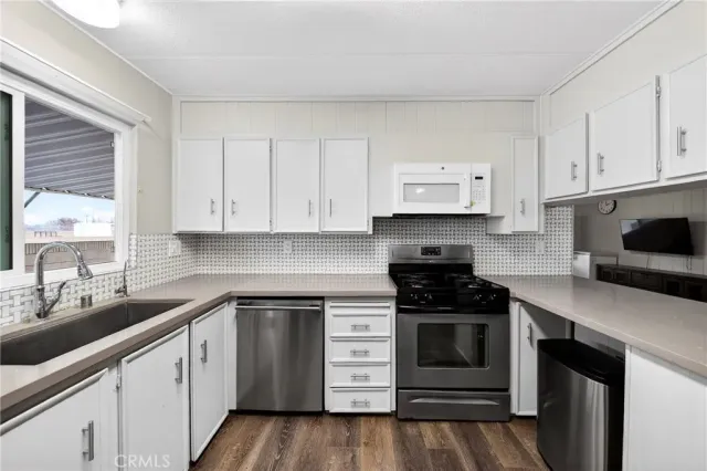 a kitchen with cabinets appliances and a sink