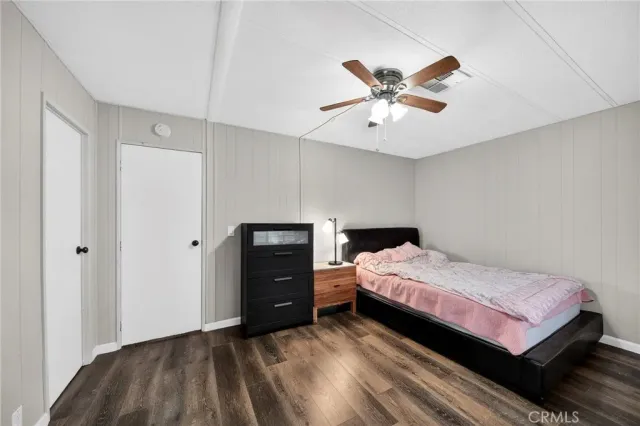 a bedroom with a bed and a ceiling fan