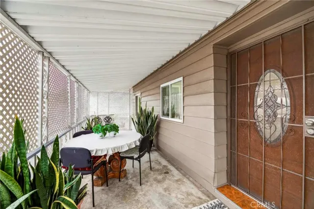 a backyard of a house with table and chairs