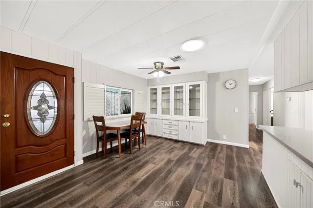 a view of a livingroom with furniture wooden floor a chandelier