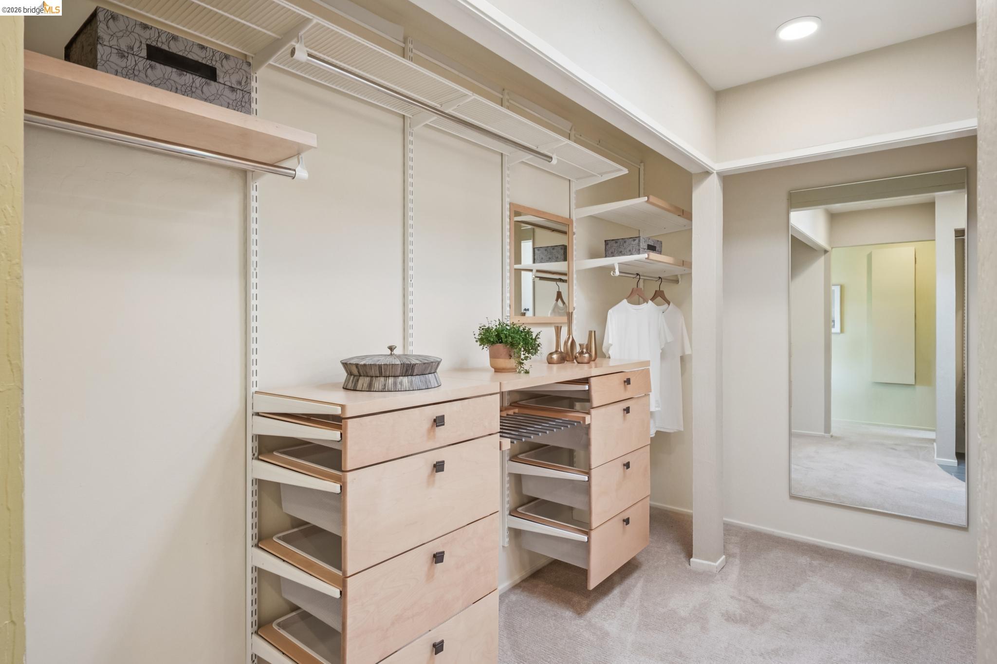 576 Vistamont Avenue Berkeley, CA 94708 - Photo 21 of 33 Custom closet system featuring built-in light wood-finish drawers, adjustable shelving, and hanging rods
