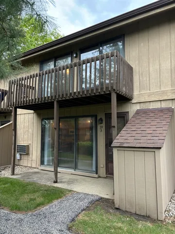 a view of a house with a porch and a floor to ceiling window