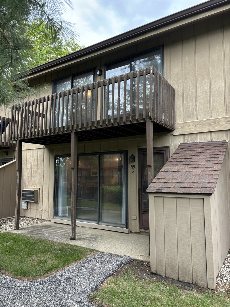 59 Vail Colony Street, Unit 3 Fox Lake, IL 60020 - Photo 1 of 24 a view of a house with a porch and a floor to ceiling window