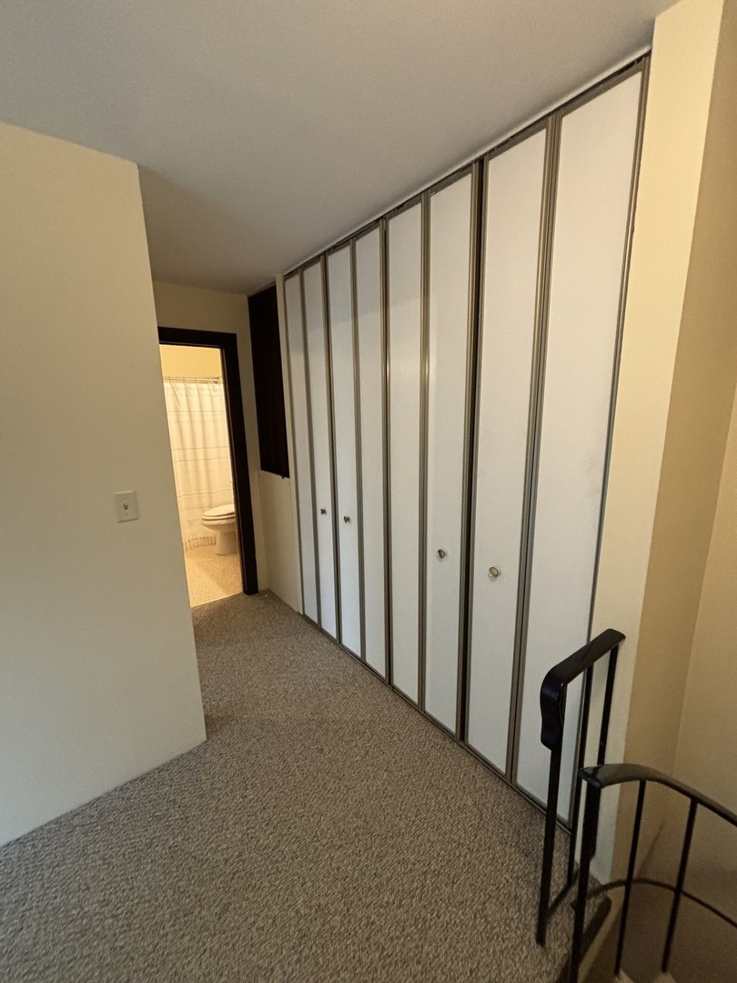 59 Vail Colony Street, Unit 3 Fox Lake, IL 60020 - Photo 14 of 24 a view of a hallway with wooden floor and staircase