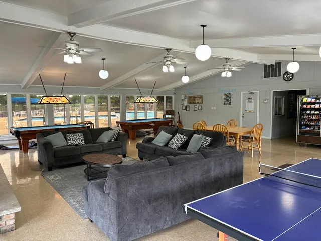 a living room with lots of furniture and chandelier