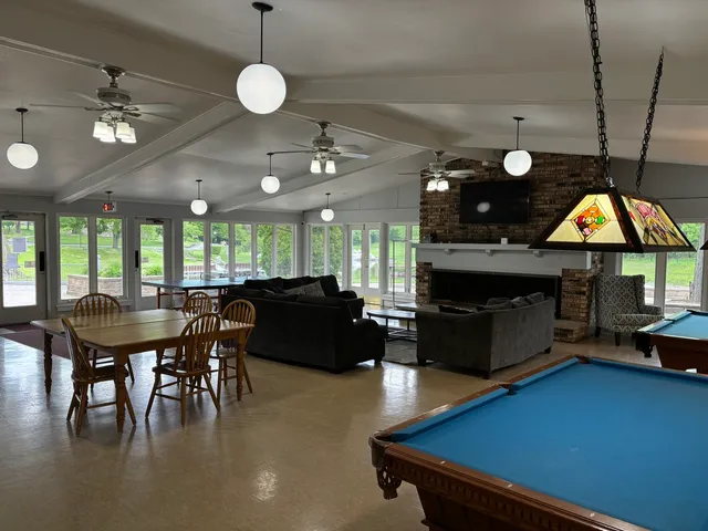 a living room with furniture a dining table and kitchen view