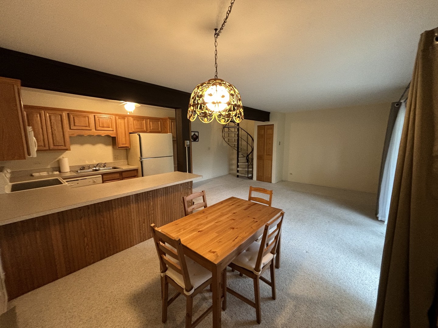 59 Vail Colony Street, Unit 3 Fox Lake, IL 60020 - Photo 2 of 24 a dining room with a table chairs and a kitchen view