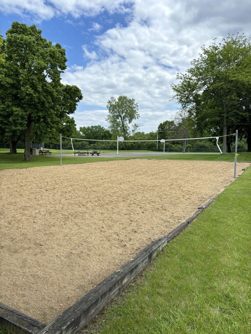 59 Vail Colony Street, Unit 3 Fox Lake, IL 60020 - Photo 21 of 24 a view of a lake with houses in the background