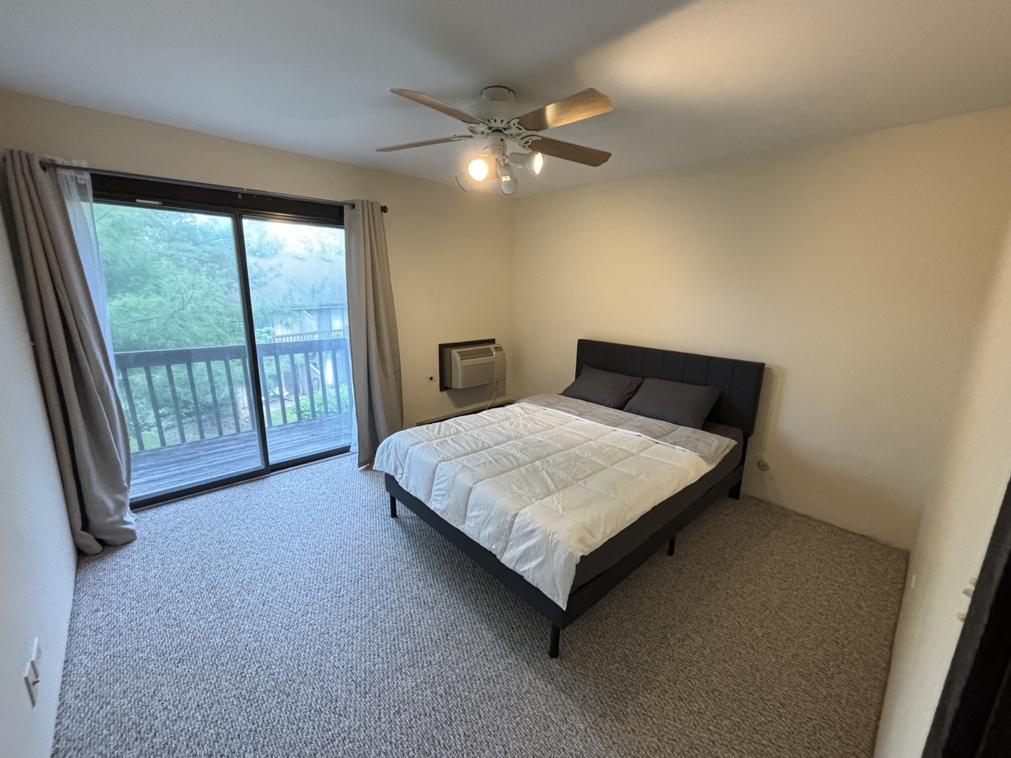 59 Vail Colony Street, Unit 3 Fox Lake, IL 60020 - Photo 9 of 24 a bedroom with a bed and a large window