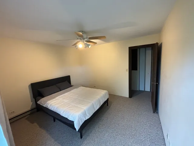 a bedroom with a bed and lamp