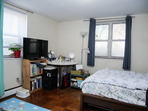 a bedroom with a bed and a flat screen tv
