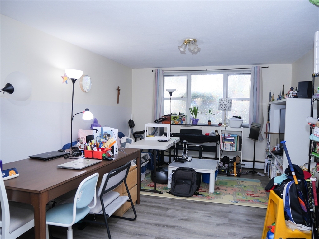 217 Kent Street, Unit 1 Brookline, MA 02446 - Photo 6 of 8 a work room with furniture and wooden floor