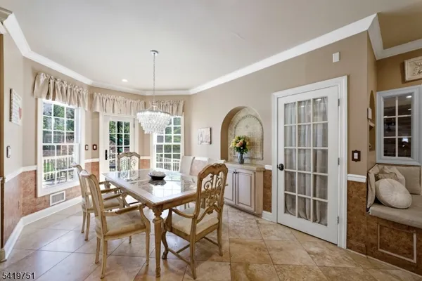 a spacious bedroom with a bed a dresser and a large window