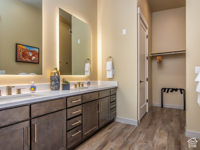 2331 Mesa Road, Unit E3 Moab, UT 84532 - Photo 18 of 71 Bathroom with double vanity, light wood-style flooring, and a spacious closet
