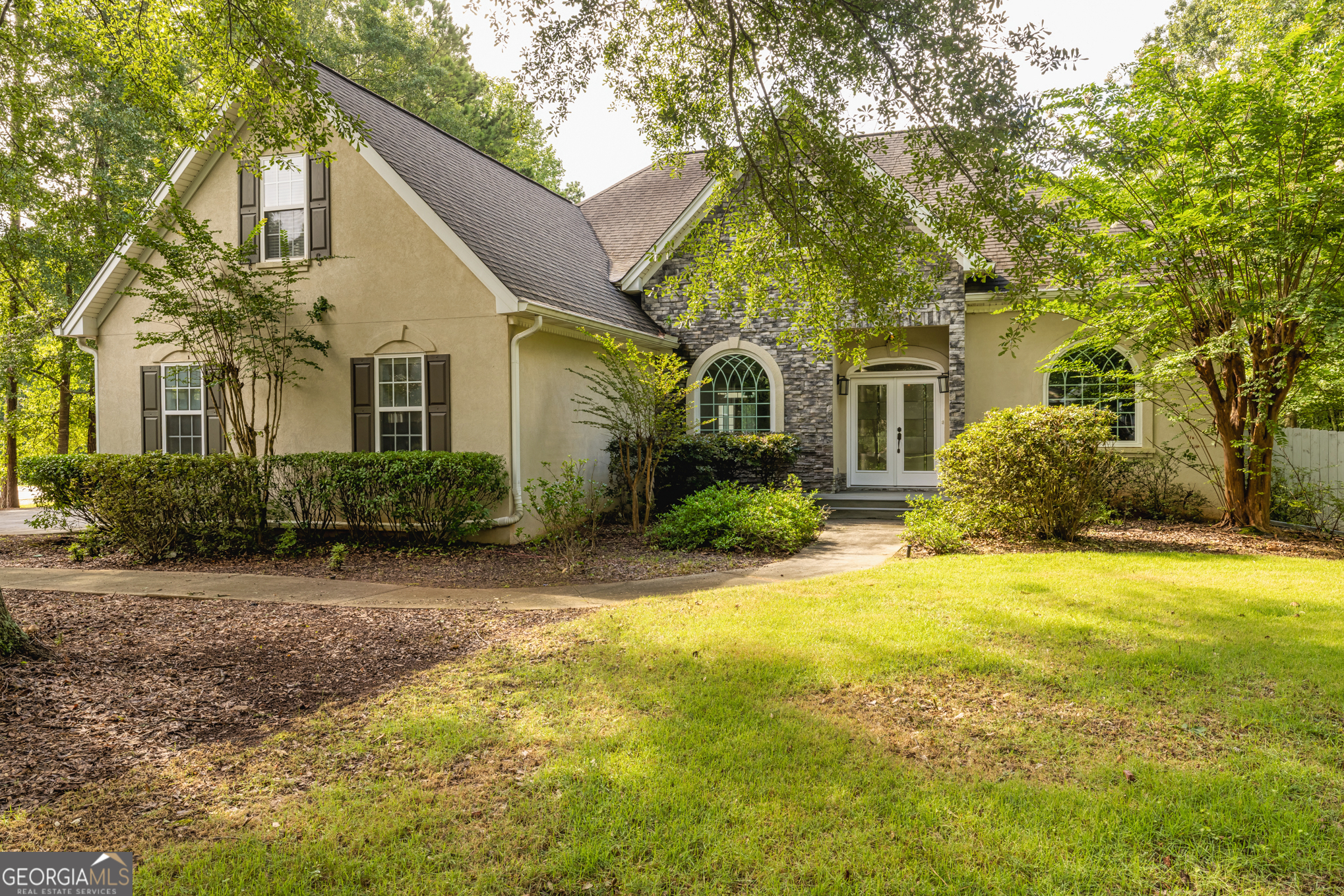 16 Enclave Lane Newnan, GA 30263 - Photo 1 of 1 a front view of house with yard and trees around
