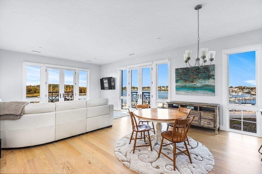 10 Shipyard Drive, Unit 312 Hingham, MA 02043 - Photo 1 of 35 a living room with furniture a dining table and a floor to ceiling window