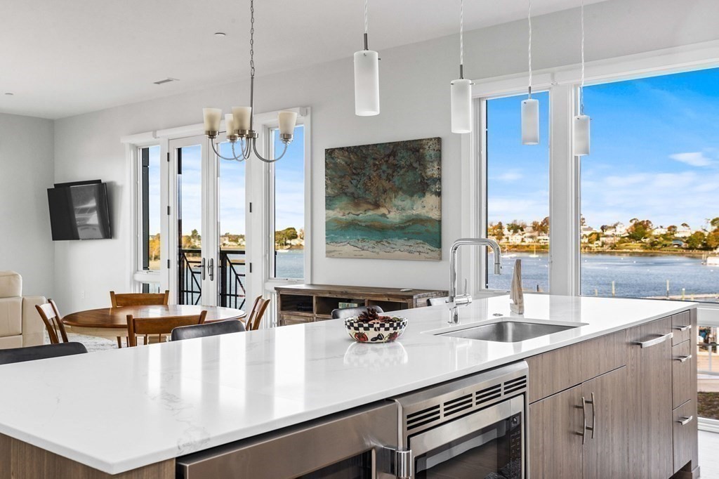 10 Shipyard Drive, Unit 312 Hingham, MA 02043 - Photo 13 of 35 a kitchen with a sink a counter and living room view