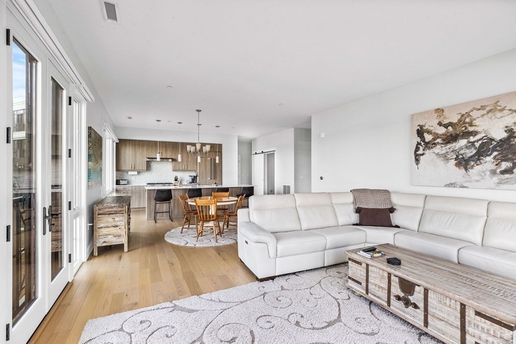 10 Shipyard Drive, Unit 312 Hingham, MA 02043 - Photo 16 of 35 a living room with furniture and a wooden floor