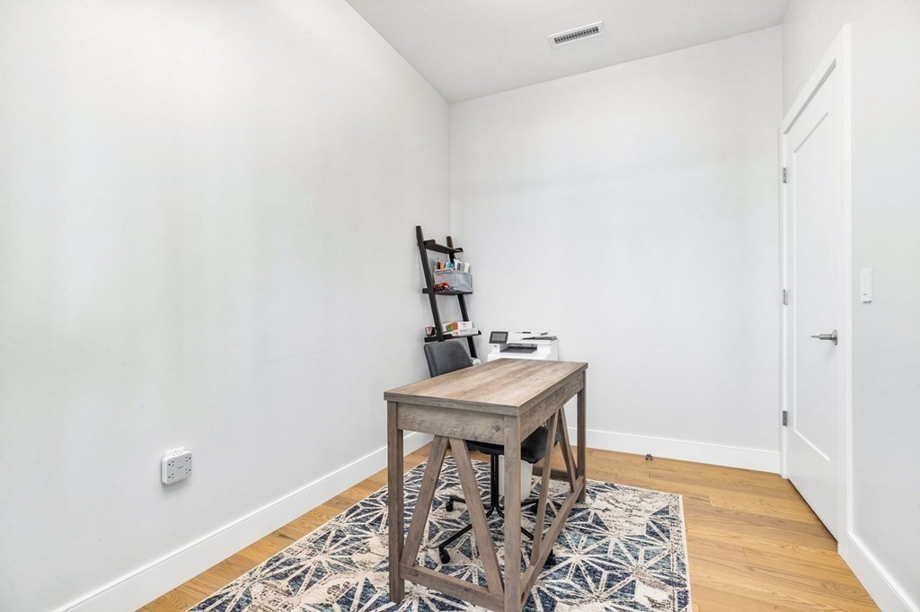 10 Shipyard Drive, Unit 312 Hingham, MA 02043 - Photo 17 of 35 a view of a room with a table and chairs