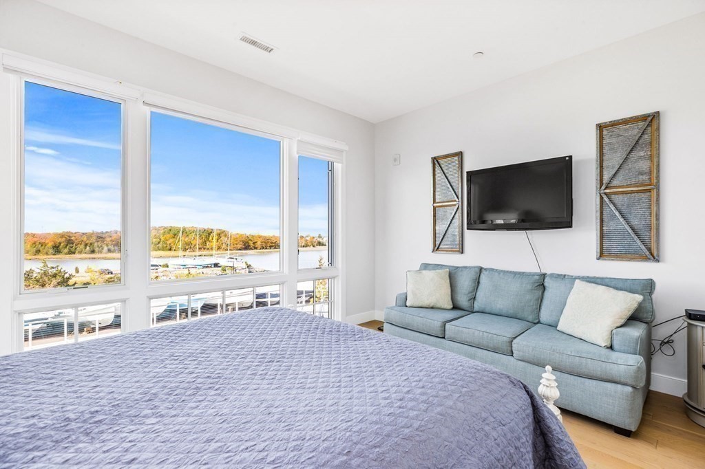 10 Shipyard Drive, Unit 312 Hingham, MA 02043 - Photo 20 of 35 a living room with furniture and a flat screen tv