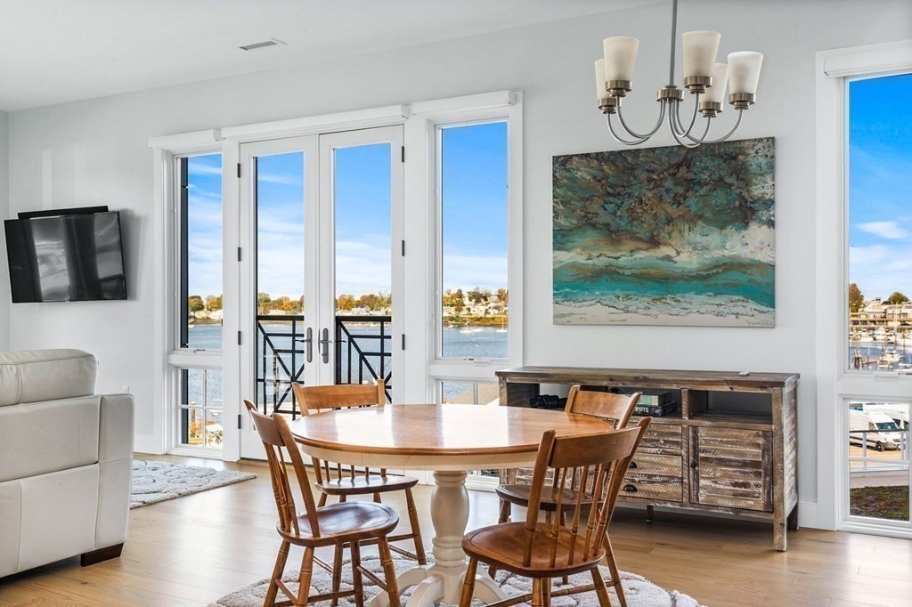 10 Shipyard Drive, Unit 312 Hingham, MA 02043 - Photo 2 of 35 a view of a dining room with furniture wooden floor and a chandelier