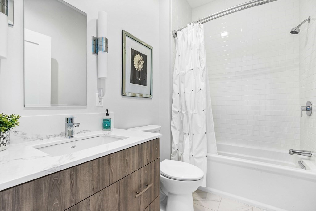 10 Shipyard Drive, Unit 312 Hingham, MA 02043 - Photo 21 of 35 a bathroom with a sink toilet a mirror and shower