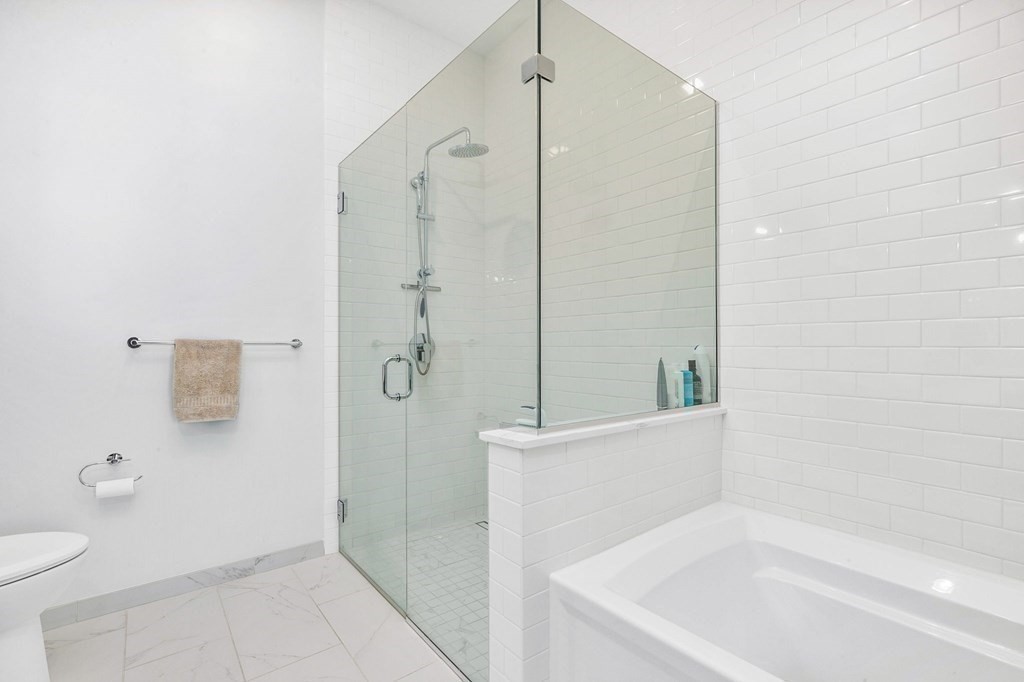 10 Shipyard Drive, Unit 312 Hingham, MA 02043 - Photo 27 of 35 a bathroom with a bathtub and a shower