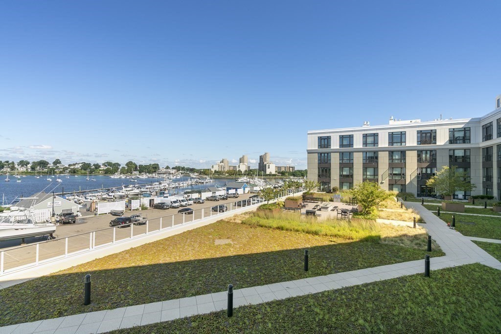 10 Shipyard Drive, Unit 312 Hingham, MA 02043 - Photo 34 of 35 a view of a swimming pool with a lawn chairs under an umbrella