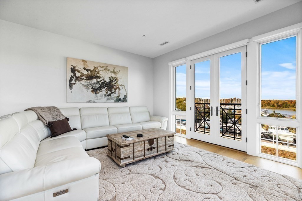 10 Shipyard Drive, Unit 312 Hingham, MA 02043 - Photo 4 of 35 a living room with furniture and large window with rug