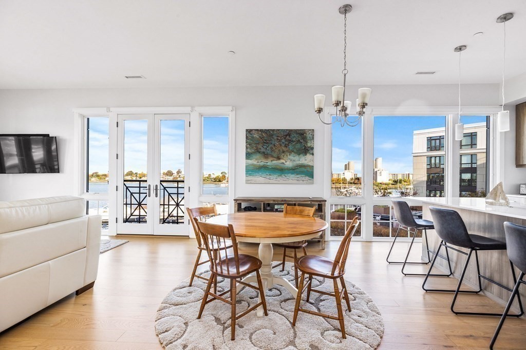 10 Shipyard Drive, Unit 312 Hingham, MA 02043 - Photo 6 of 35 a dining room with furniture a chandelier and wooden floor