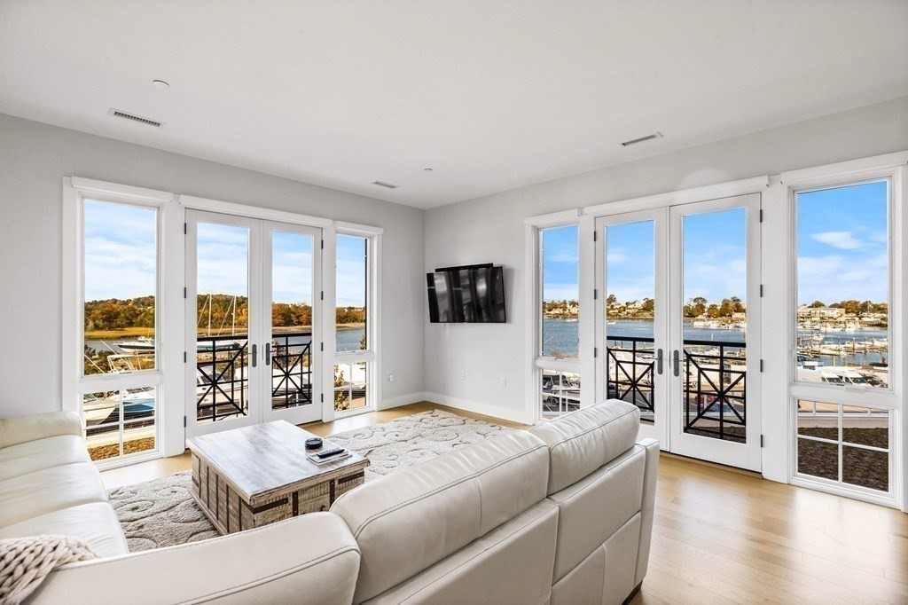10 Shipyard Drive, Unit 312 Hingham, MA 02043 - Photo 7 of 35 a living room with furniture and a flat screen tv