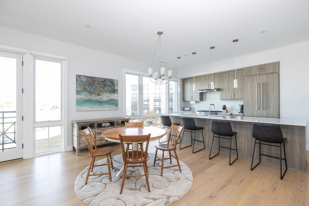 10 Shipyard Drive, Unit 312 Hingham, MA 02043 - Photo 8 of 35 a view of a dining room with furniture and wooden floor