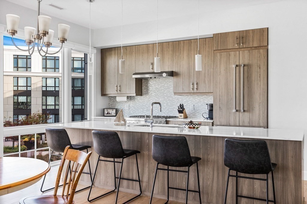 10 Shipyard Drive, Unit 312 Hingham, MA 02043 - Photo 9 of 35 a kitchen with stainless steel appliances granite countertop a sink and cabinets